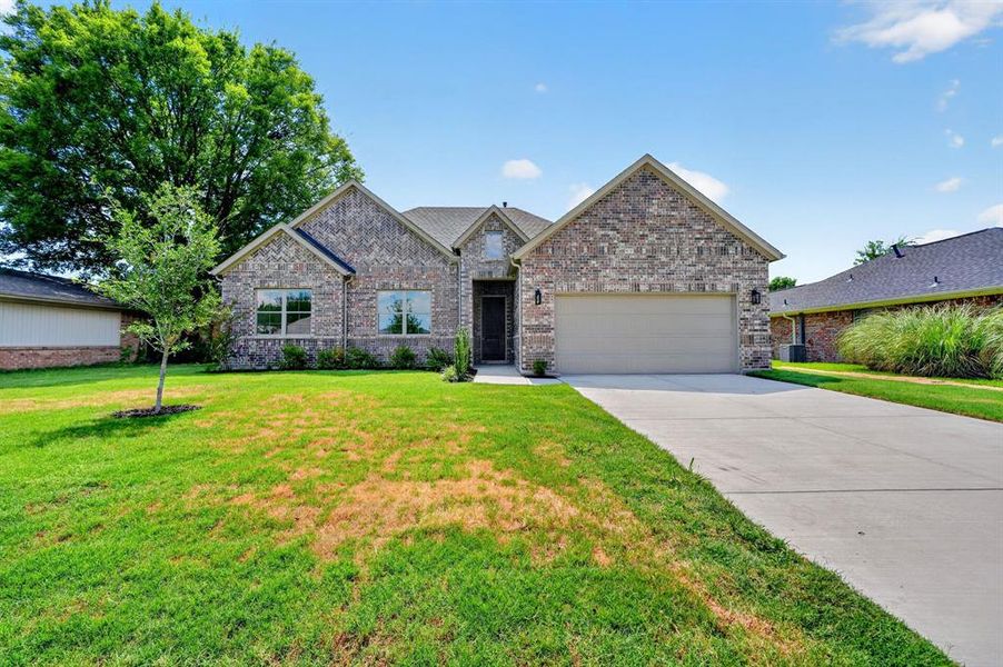 Front exterior of a new home in , Greenville, TX, highlighting curb appeal (Image 2). Front exterior of a new home in , Greenville, TX, highlighting curb appeal (Image 2).