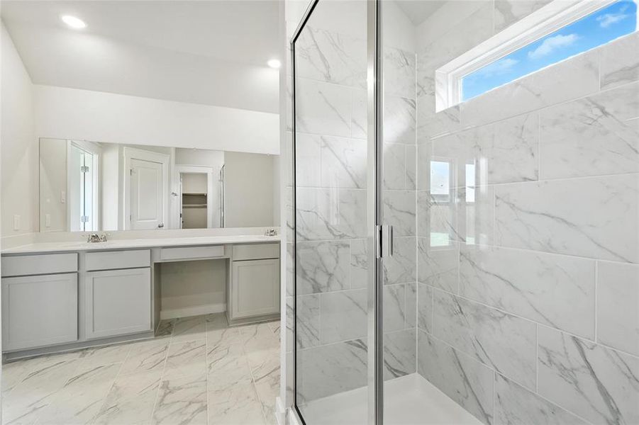 Full bathroom featuring double vanity, a marble finish shower, marble finish flooring, and recessed lighting