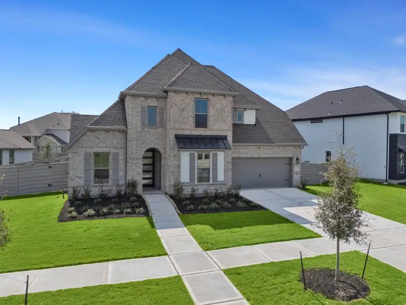 Front exterior of a new home in Pomona 60', Manvel, TX, highlighting curb appeal (Image 2).