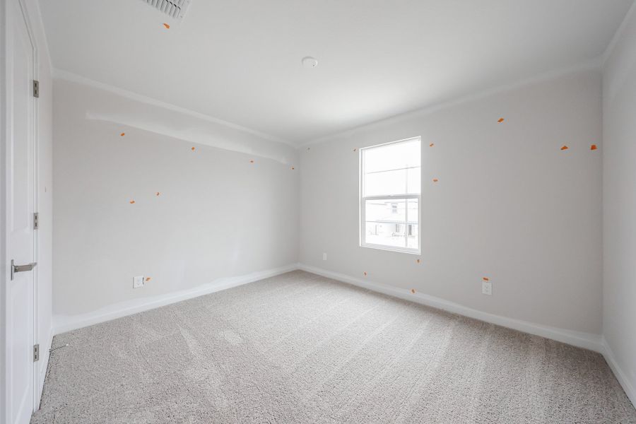 A room with a carpet and a window. A room with a carpet and a window.