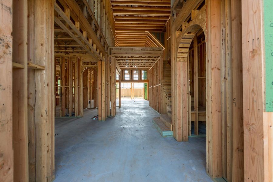 A grand passage begins to take form, where soaring lines and layered framing hint at a dramatic arrival experience yet to unfold.