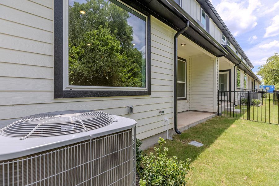 Clean, contemporary siding and dark window frames offer inviting curb appeal.