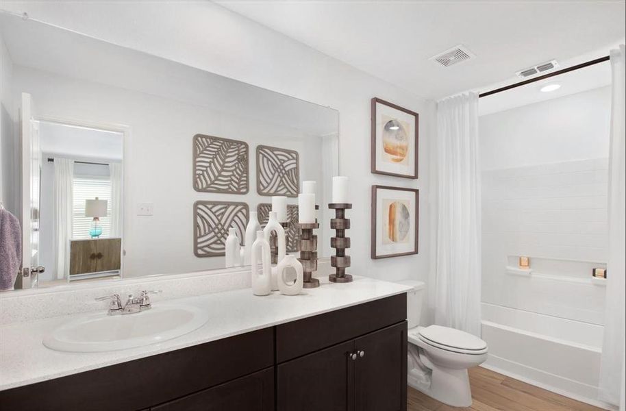 Full bathroom featuring toilet, vanity, hardwood / wood-style flooring, and shower / tub combo with curtain