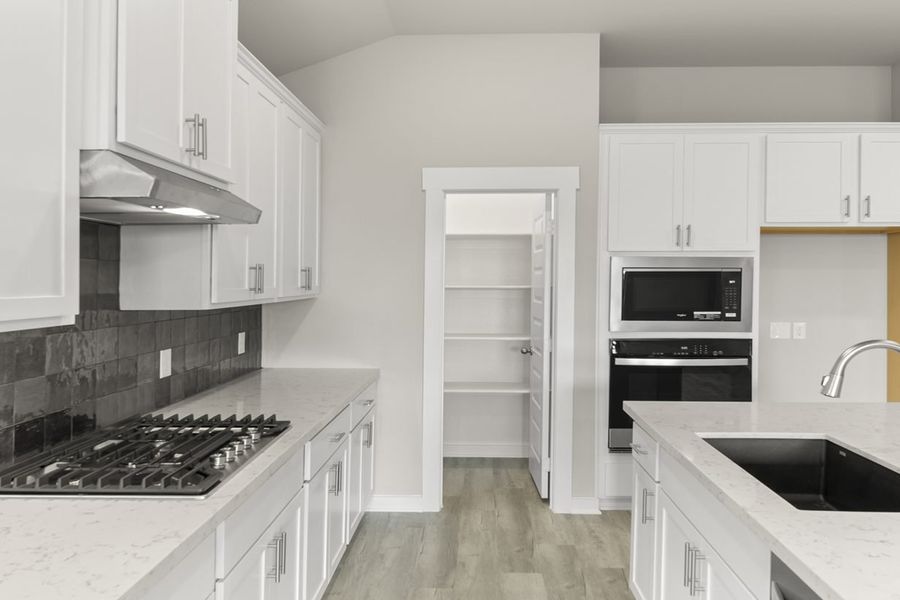 Representative furnished interior of a home built from the Hickory Sunterra 50s by Brohn Homes in Sunterra, Katy (Image 5).