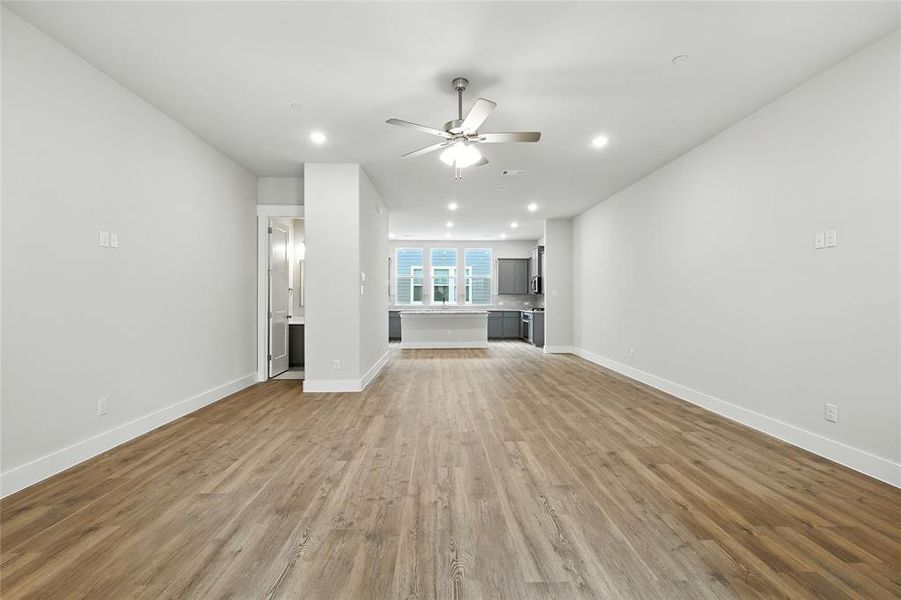 Unfurnished living room with recessed lighting, wood finished floors, and ceiling fan