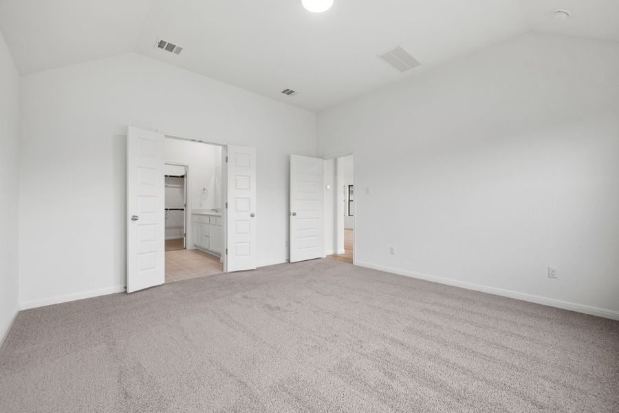 Primary Bedroom in the Quartz home plan by Trophy Signature Homes – REPRESENTATIVE PHOTO
