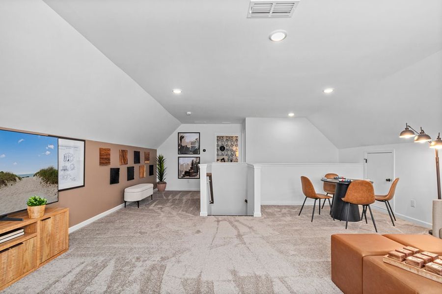 A room with a table chairs and a couch.