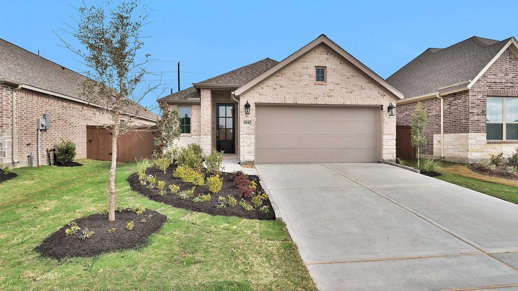 Front exterior of a new home in Meridiana, Manvel, TX, highlighting curb appeal (Image 2).