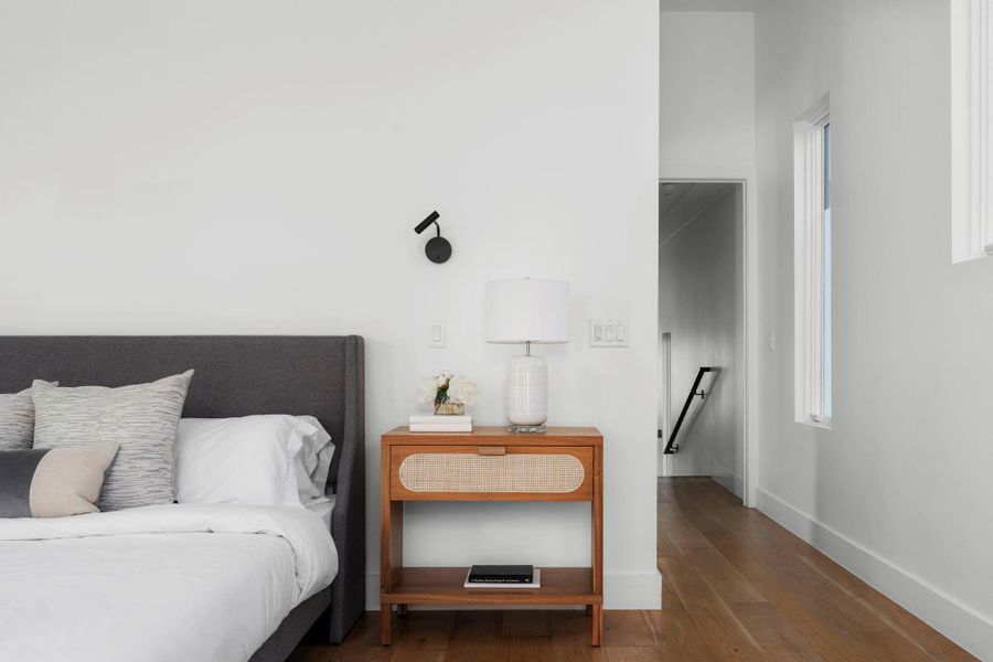 Bedroom featuring hardwood / wood-style flooring and baseboards