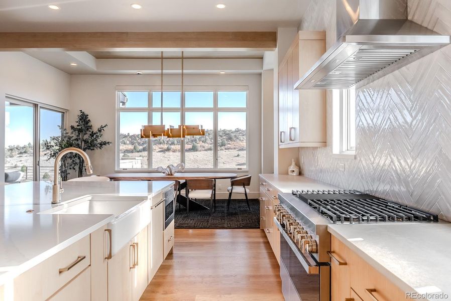 A suite of professional-grade appliances include a six-burner dual-fuel range and built-in cabinet faced refrigerator.