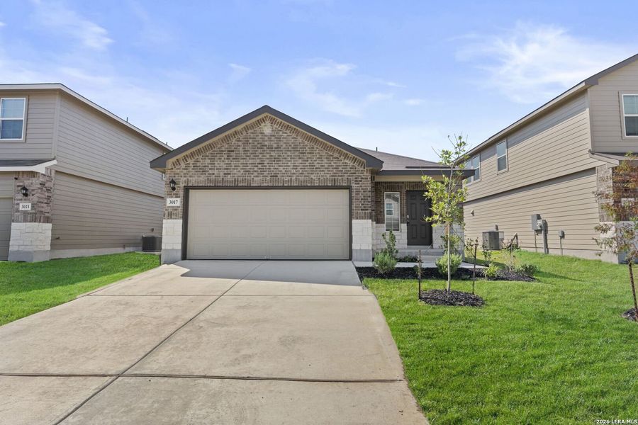 Front exterior of a new home in Laurel Vistas, San Antonio, TX, highlighting curb appeal (Image 1). Front exterior of a new home in Laurel Vistas, San Antonio, TX, highlighting curb appeal (Image 1).