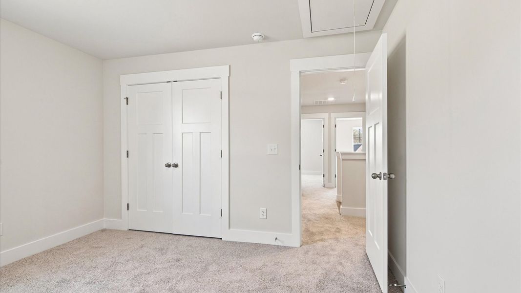 Superior comfort in this light-filled bedroom with plush carpeting and thoughtfully placed large windows