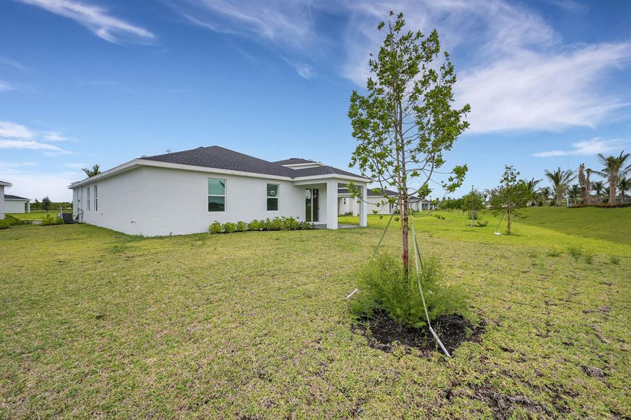 Front exterior of a new home in Seagrove: The Indies, Fort Pierce, FL, highlighting curb appeal (Image 1). Front exterior of a new home in Seagrove: The Indies, Fort Pierce, FL, highlighting curb appeal (Image 1).