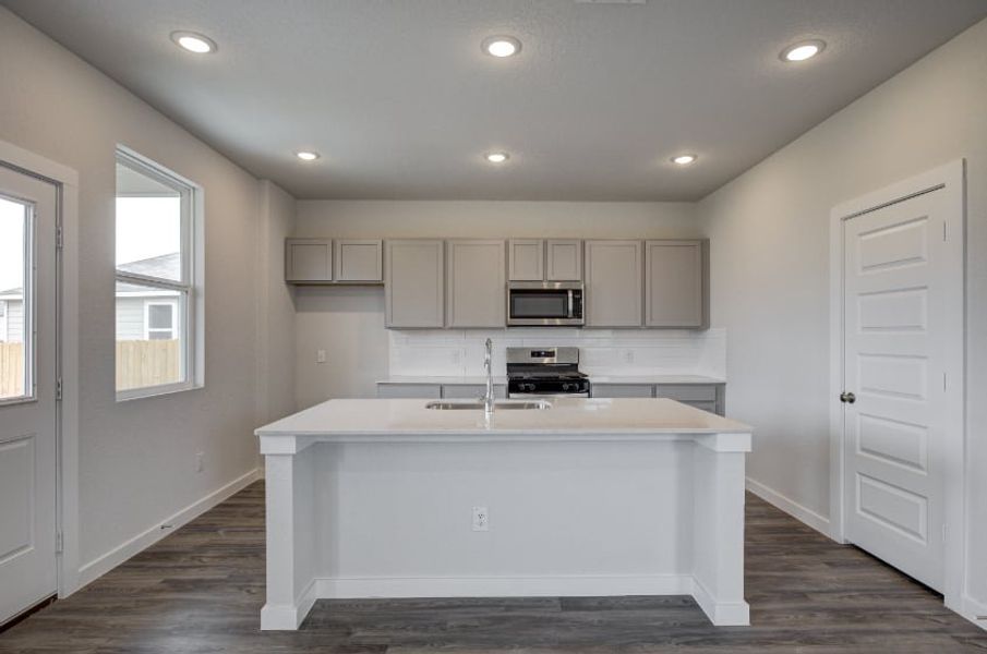 A kitchen with white cabinets. A kitchen with white cabinets.