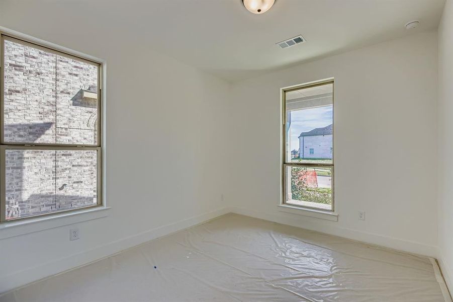 Carpeted spare room featuring baseboards Carpeted spare room featuring baseboards