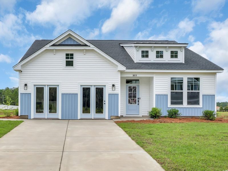 View of front of home with a front lawn, roof with shingles, and board and batten​​‌​​​​‌​​‌‌​​‌​​​‌‌​​‌​​‌​​​‌​‌​​‌‌​​​​ siding