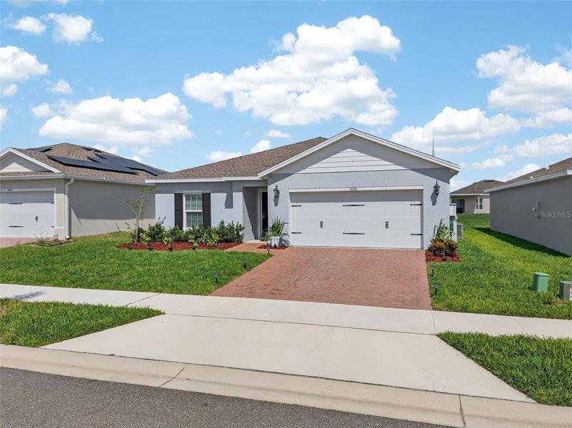 Front exterior of a new home in Laurel Glen, Haines City, FL, highlighting curb appeal (Image 23).