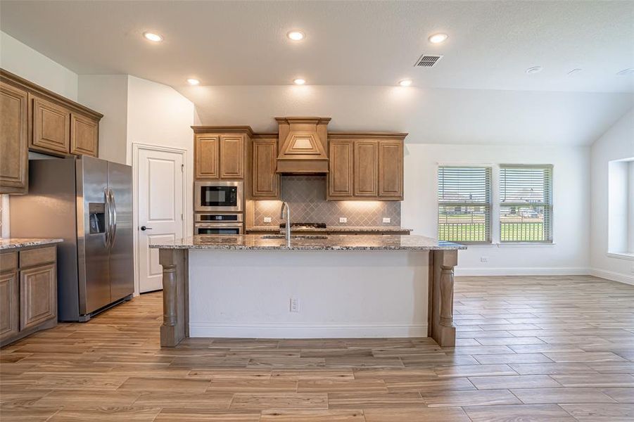 Large island in the kitchen featuring Frigidaire appliances. Large island in the kitchen featuring Frigidaire appliances.