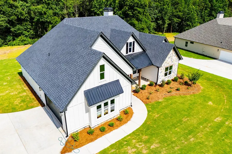 Front exterior of a new home in WOODMONT RESERVE, Roopville, GA, highlighting curb appeal (Image 40).