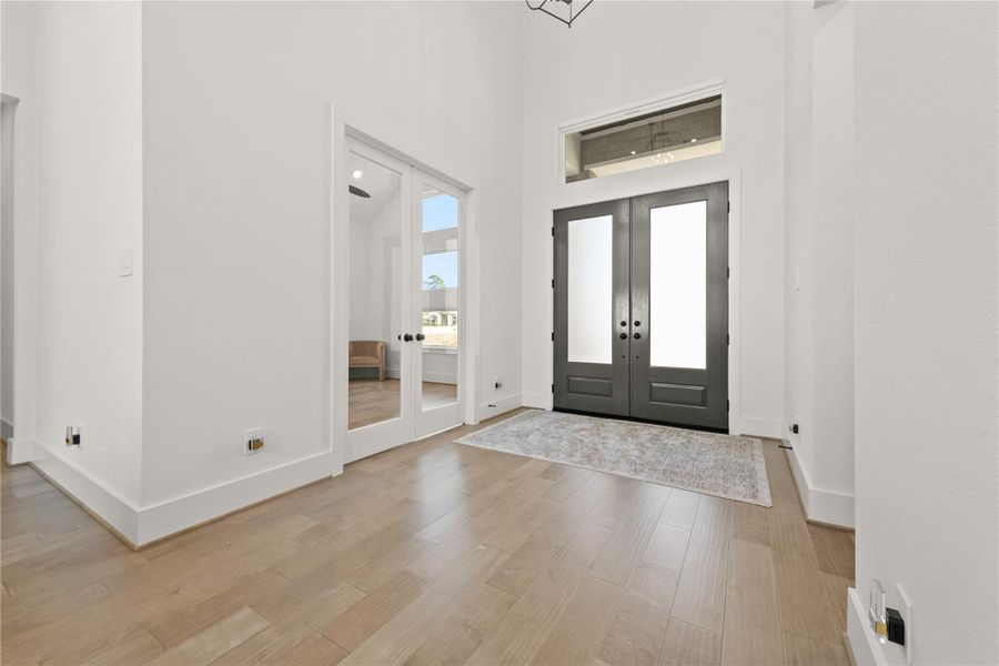 Double door entry with soaring ceilings