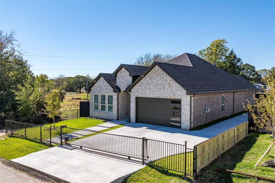 View of front of property featuring a garage and a front yard