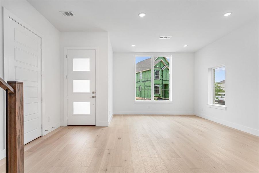 Foyer with light hardwood / wood-style floors