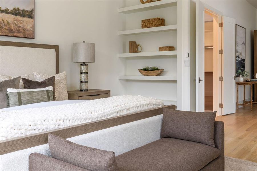 Bedroom with light wood finished floors and a spacious closet