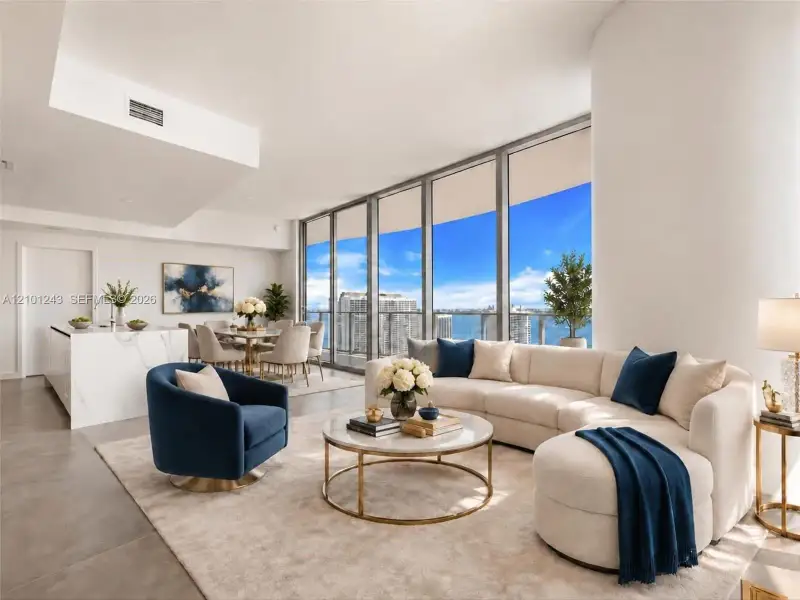 Open-concept floor plan featuring floor-to-ceiling windows, a stone-surfaced kitchen island, and a balcony with water scenery Open-concept floor plan featuring floor-to-ceiling windows, a stone-surfaced kitchen island, and a balcony with water scenery