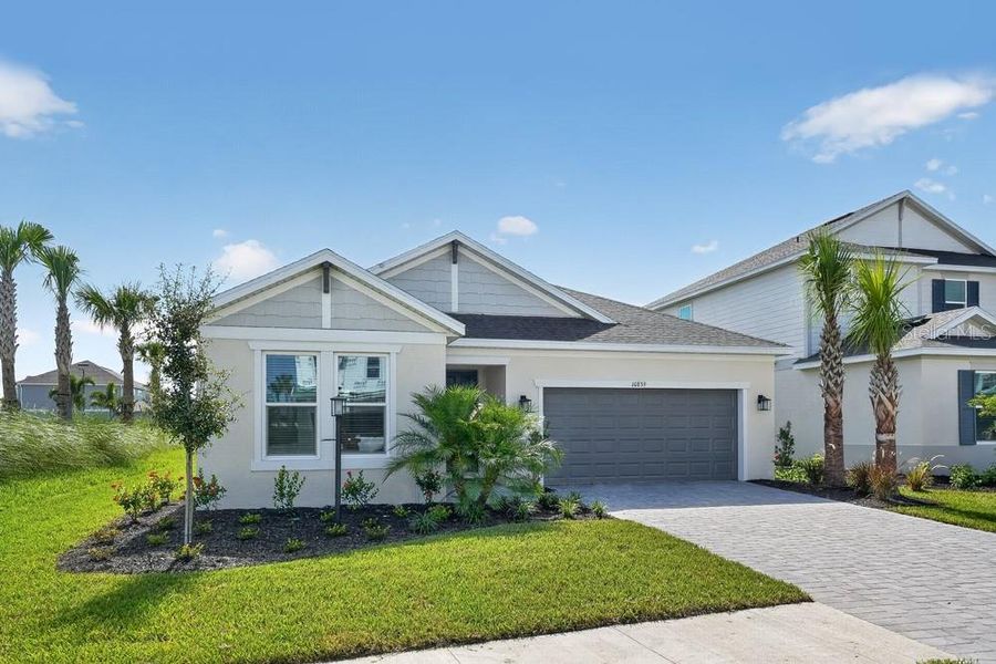 Front exterior of a new home in Skye Ranch Community Group Page, Sarasota, FL, highlighting curb appeal (Image 2). Front exterior of a new home in Skye Ranch Community Group Page, Sarasota, FL, highlighting curb appeal (Image 2).