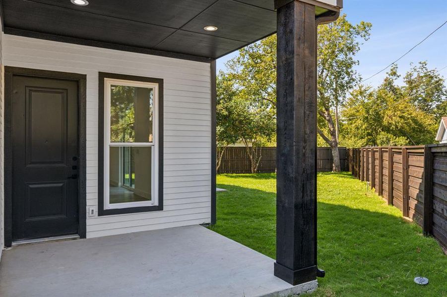 Back of property featuring a yard and a patio area