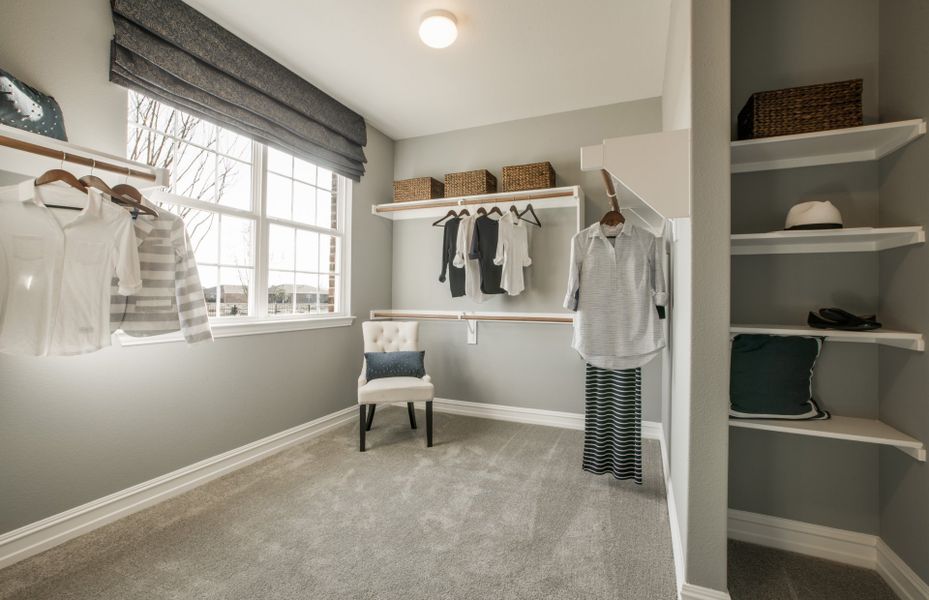 Amazing owner's walk-in closet with wood shelving and rods