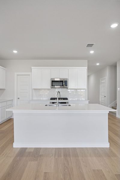 Kitchen in the Masters home plan by Trophy Signature Homes – REPRESENTATIVE PHOTO