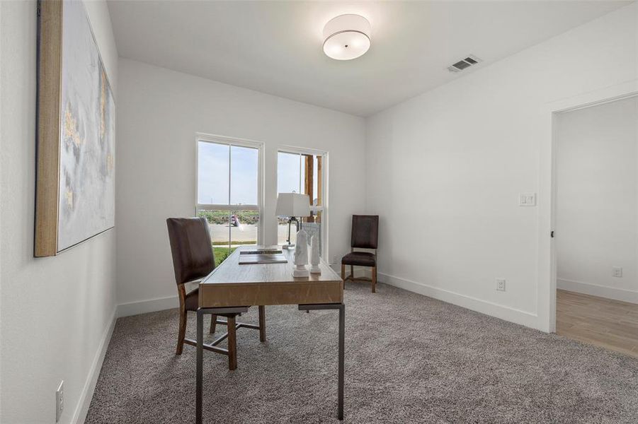 Home office with hardwood / wood-style floors