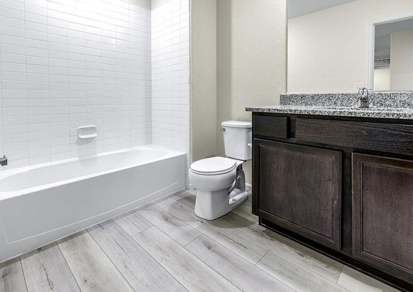 Secondary bathroom with a dual shower and bathtub.