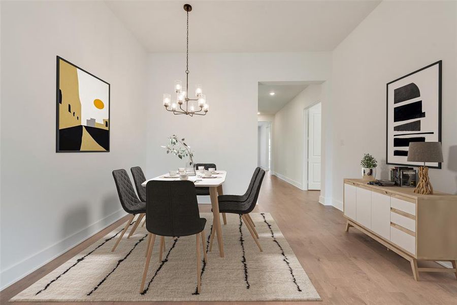 Dining space featuring light wood finished floors and a chandelier Dining space featuring light wood finished floors and a chandelier