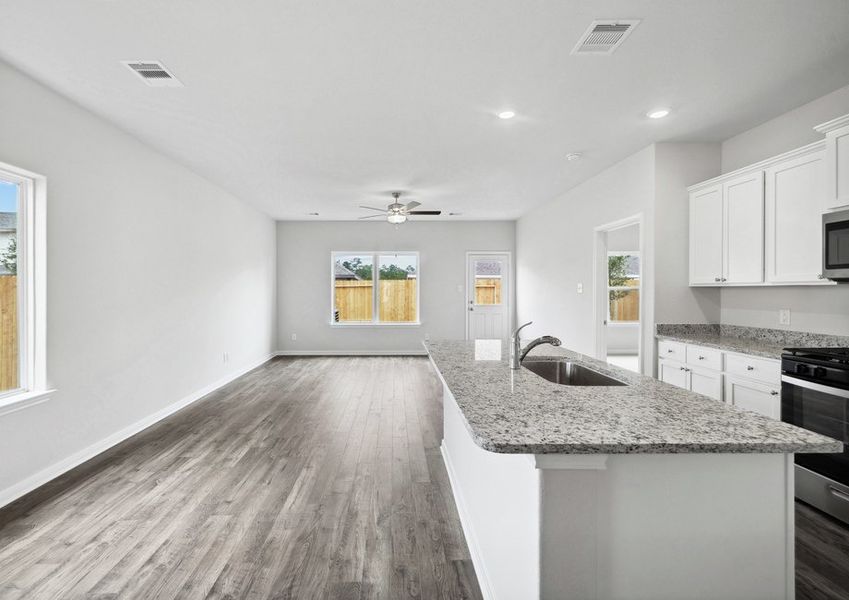 A large window in the family room overlooks the backyard A large window in the family room overlooks the backyard