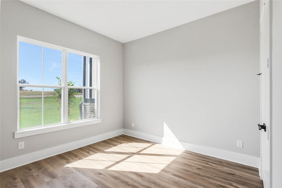 Bright and inviting, this bedroom features ample natural light and serene views, perfect for a cozy retreat.