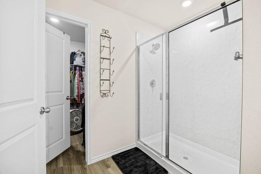 Spacious shower enclosure with clear glass doors and a bright interior Spacious shower enclosure with clear glass doors and a bright interior