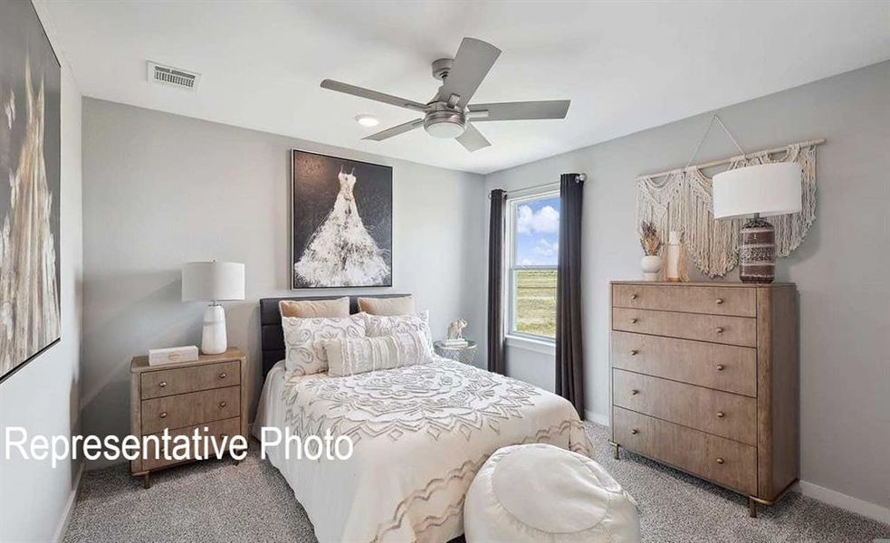 This room features a ceiling fan, a window with views of an expansive outdoor area, and soft grey walls