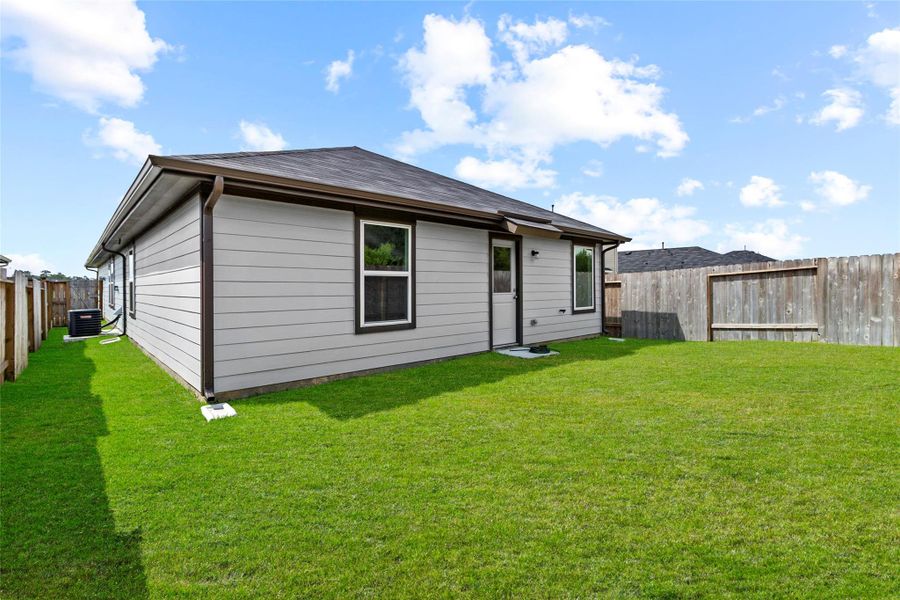 Exterior details and patio area of a home in The Canopies, Splendora (Image 4).