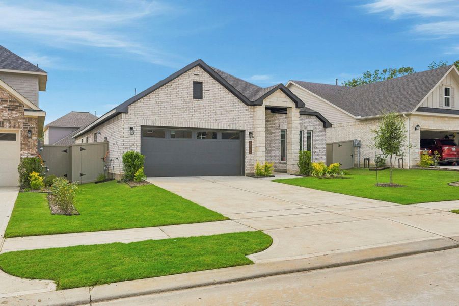 Front exterior of a new home in Audubon, Magnolia, TX, highlighting curb appeal (Image 19). Front exterior of a new home in Audubon, Magnolia, TX, highlighting curb appeal (Image 19).