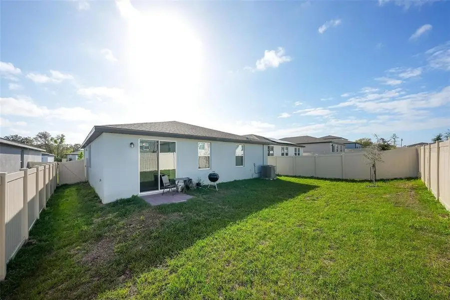 Exterior details and patio area of a home in Deer Run at Crosswinds, Davenport (Image 3).