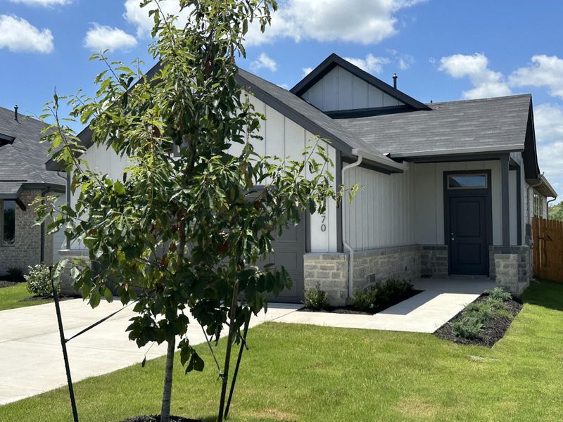 Front exterior of a new home in Trinity Ranch, Elgin, TX, highlighting curb appeal (Image 1). Front exterior of a new home in Trinity Ranch, Elgin, TX, highlighting curb appeal (Image 1).