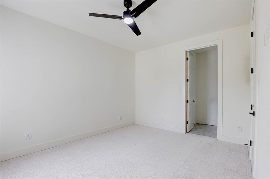 Spare room featuring ceiling fan and light colored carpet