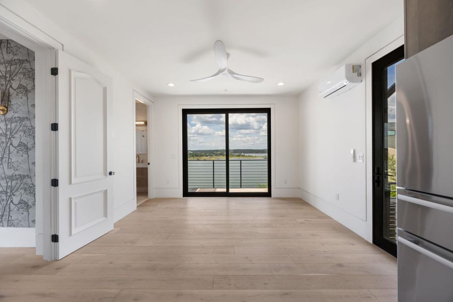 Hardwood floors and a wide sliding glass door define this airy room, providing tranquil views of the waterfront. Hardwood floors and a wide sliding glass door define this airy room, providing tranquil views of the waterfront.
