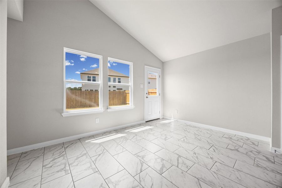 Vaulted ceilings and polished tile flooring elevate this light-filled dining space. Vaulted ceilings and polished tile flooring elevate this light-filled dining space.