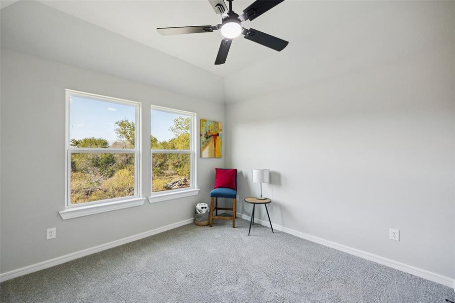 Living area with carpet floors and ceiling fan