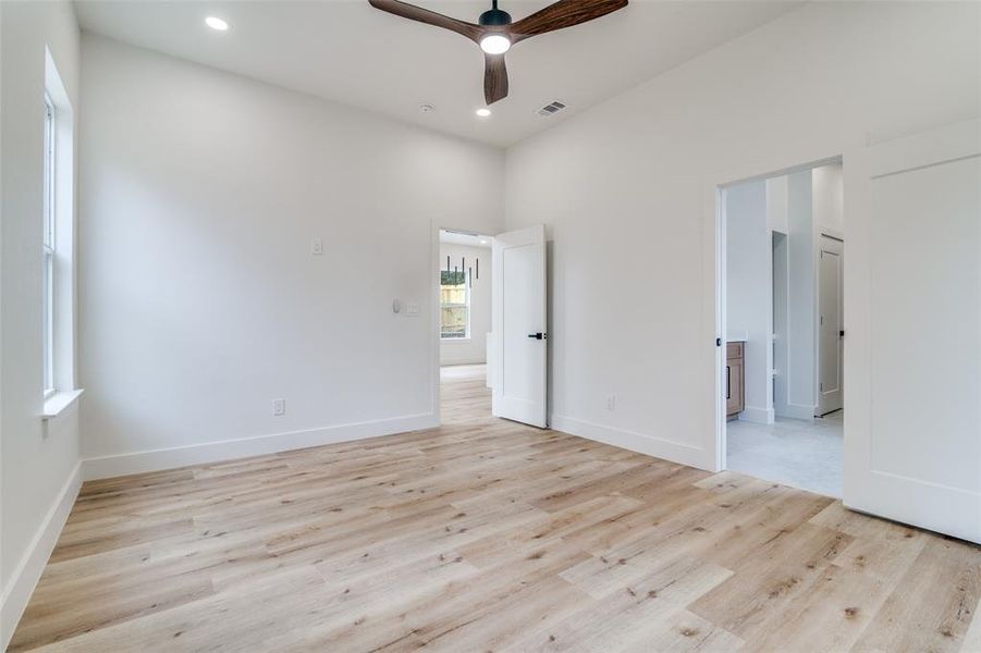 Empty room with light wood-style floors, recessed lighting, and a ceiling fan