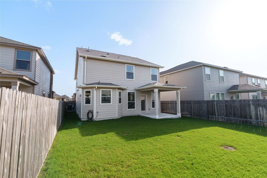 A spacious, verdant yard offers abundant room for leisure, complementing the home's covered patio. A spacious, verdant yard offers abundant room for leisure, complementing the home's covered patio.