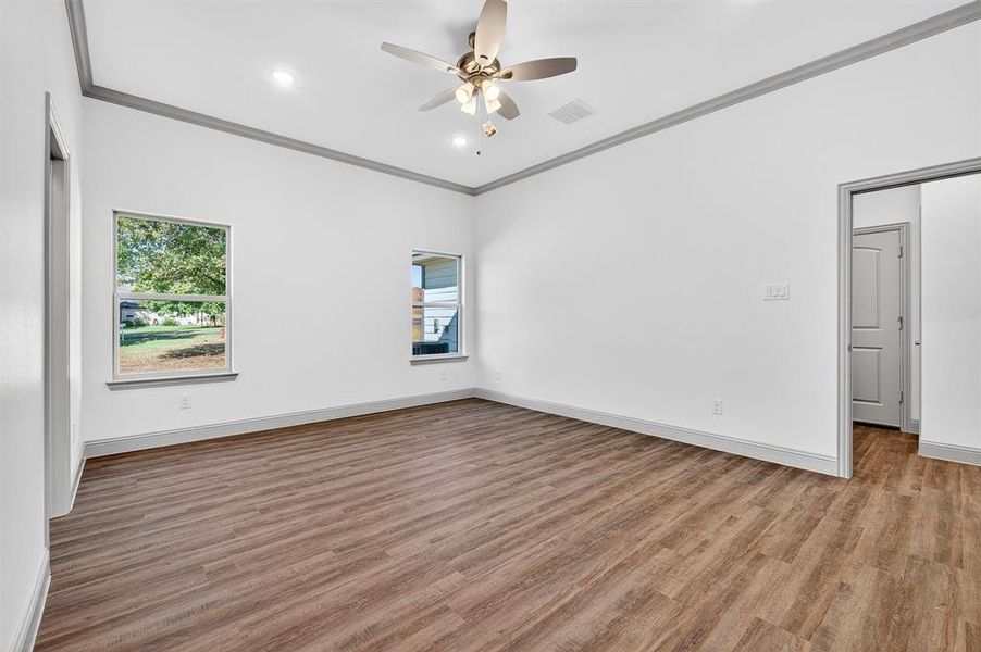 Unfurnished room with ornamental molding, light wood-type flooring, recessed lighting, and ceiling fan
